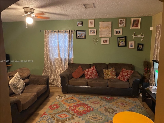 8130 SW 7th Ct, North Lauderdale, FL 33068 - living area featuring a textured ceiling, a ceiling fan, and wood finished floors