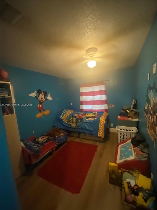 8130 SW 7th Ct, North Lauderdale, FL 33068 - bedroom featuring wood finished floors and a textured ceiling