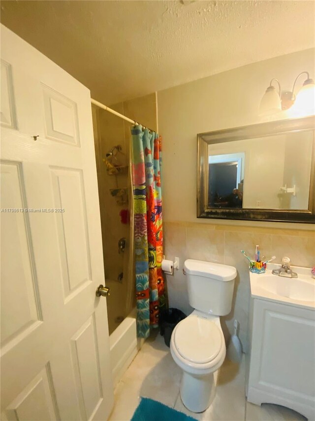 8130 SW 7th Ct, North Lauderdale, FL 33068 - bathroom featuring toilet, vanity, shower / bathtub combination with curtain, a textured ceiling, and tile walls