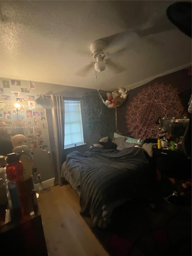 8130 SW 7th Ct, North Lauderdale, FL 33068 - bedroom with wood finished floors, a textured ceiling, a ceiling fan, and baseboards