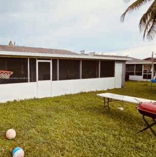 8130 SW 7th Ct, North Lauderdale, FL 33068 - back of house featuring a sunroom and a yard
