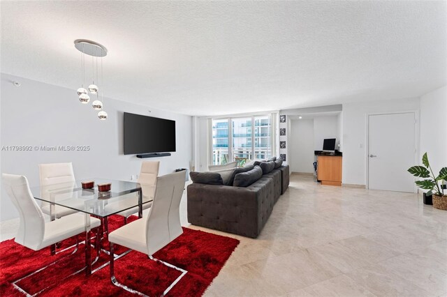 6917 Collins Ave Unit 607, Miami Beach, FL 33141 - dining space with a textured ceiling