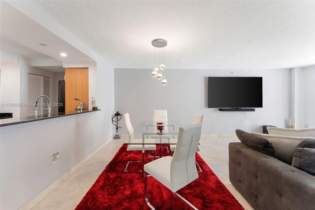 6917 Collins Ave Unit 607, Miami Beach, FL 33141 - tiled dining area featuring recessed lighting, a sink, and a textured ceiling
