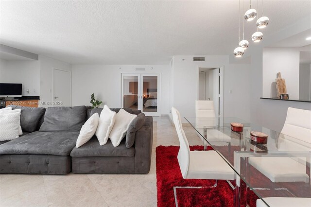 6917 Collins Ave Unit 607, Miami Beach, FL 33141 - tiled living area with a textured ceiling