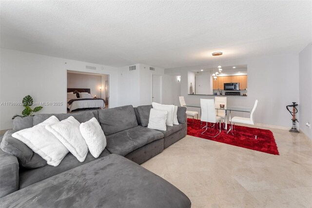 6917 Collins Ave Unit 607, Miami Beach, FL 33141 - living area featuring a textured ceiling