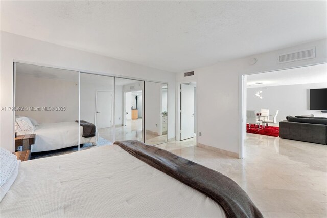 6917 Collins Ave Unit 607, Miami Beach, FL 33141 - bedroom with a closet, light tile patterned floors, and baseboards