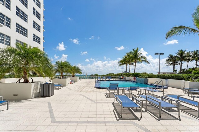 6917 Collins Ave Unit 607, Miami Beach, FL 33141 - community pool with fence and a patio area