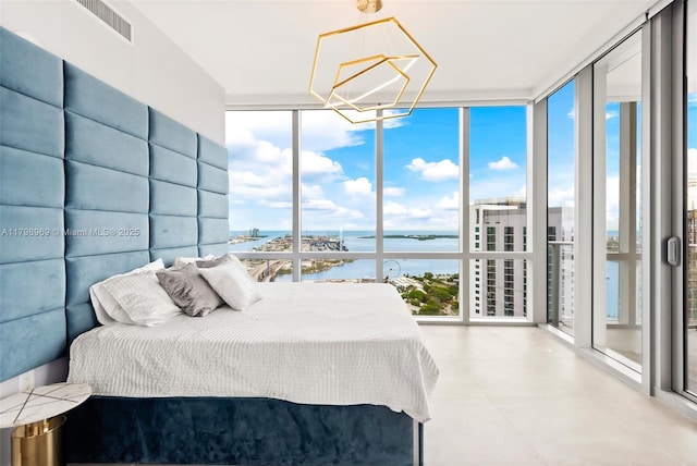 851 NE 1st Ave Unit 4011, Miami, FL 33132 - bedroom with a wall of windows, a water view, and a chandelier