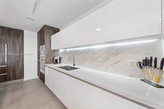 851 NE 1st Ave Unit 4011, Miami, FL 33132 - kitchen featuring a sink, modern cabinets, light countertops, and white cabinetry