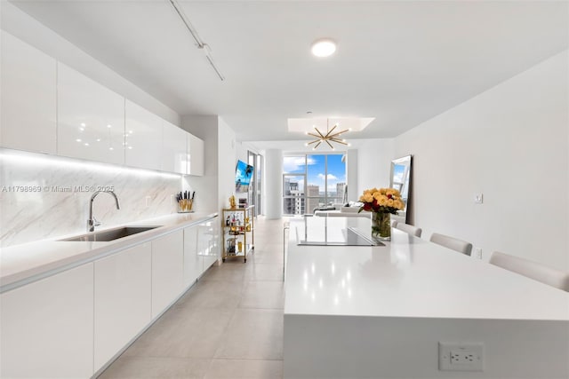 851 NE 1st Ave Unit 4011, Miami, FL 33132 - kitchen featuring a sink, modern cabinets, black electric stovetop, and white cabinets