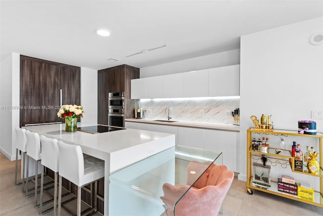 851 NE 1st Ave Unit 4011, Miami, FL 33132 - kitchen with a sink, a kitchen breakfast bar, a kitchen island, modern cabinets, and recessed lighting