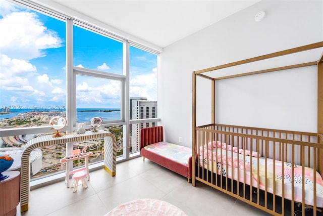 851 NE 1st Ave Unit 4011, Miami, FL 33132 - bedroom with expansive windows, a water view, and tile patterned floors