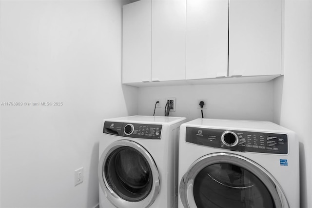 851 NE 1st Ave Unit 4011, Miami, FL 33132 - laundry area with cabinet space and washing machine and clothes dryer