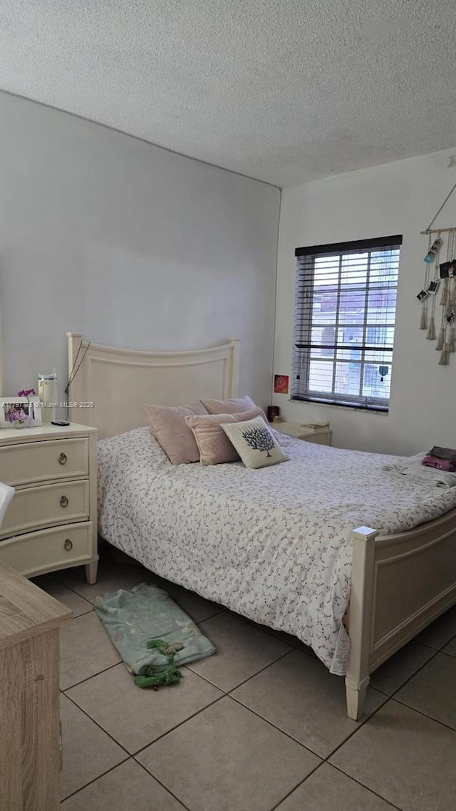 6425 SW 130th Pl Unit 704, Miami, FL 33183 - bedroom with tile patterned floors and a textured ceiling
