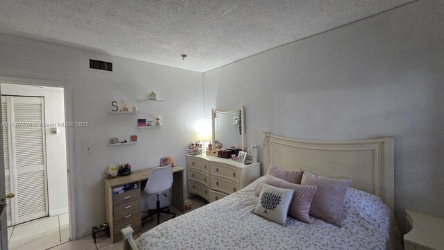 6425 SW 130th Pl Unit 704, Miami, FL 33183 - bedroom with light tile patterned floors and a textured ceiling