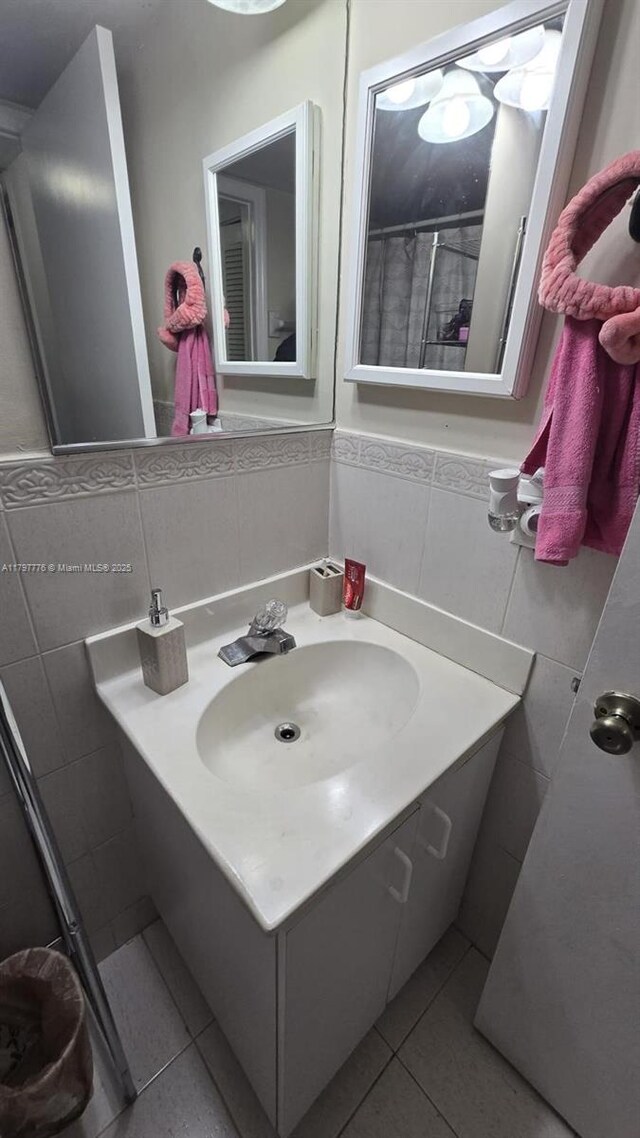 6425 SW 130th Pl Unit 704, Miami, FL 33183 - bathroom featuring tile walls, tile patterned floors, vanity, and a wainscoted wall
