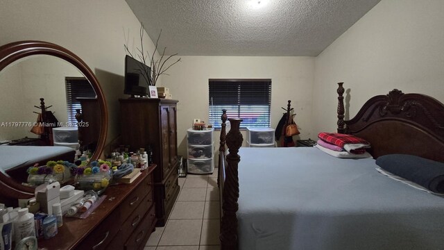 6425 SW 130th Pl Unit 704, Miami, FL 33183 - bedroom with light tile patterned floors and a textured ceiling