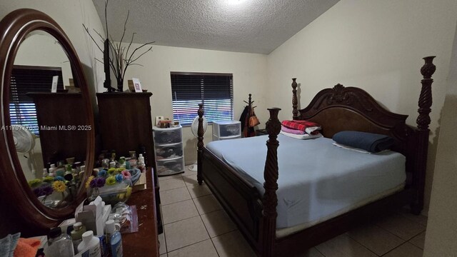 6425 SW 130th Pl Unit 704, Miami, FL 33183 - bedroom featuring a textured ceiling and tile patterned floors
