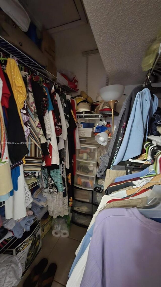 6425 SW 130th Pl Unit 704, Miami, FL 33183 - walk in closet with tile patterned floors and attic access