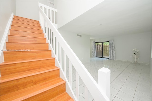 stairs featuring tile patterned flooring