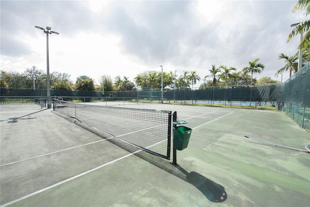 view of tennis court with fence