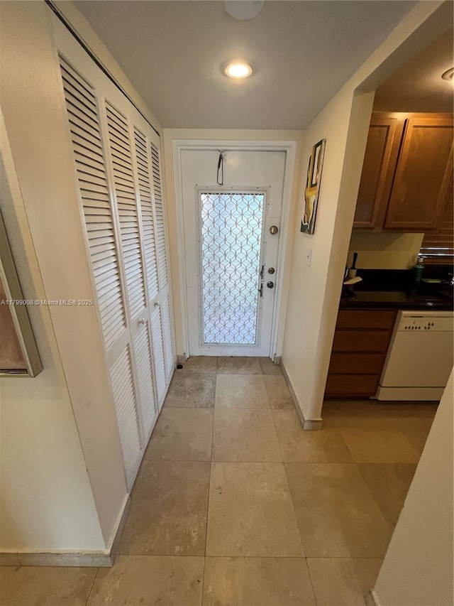 9420 Sunrise Lakes Blvd Unit 106, Sunrise, FL 33322 - foyer with baseboards and light tile patterned flooring
