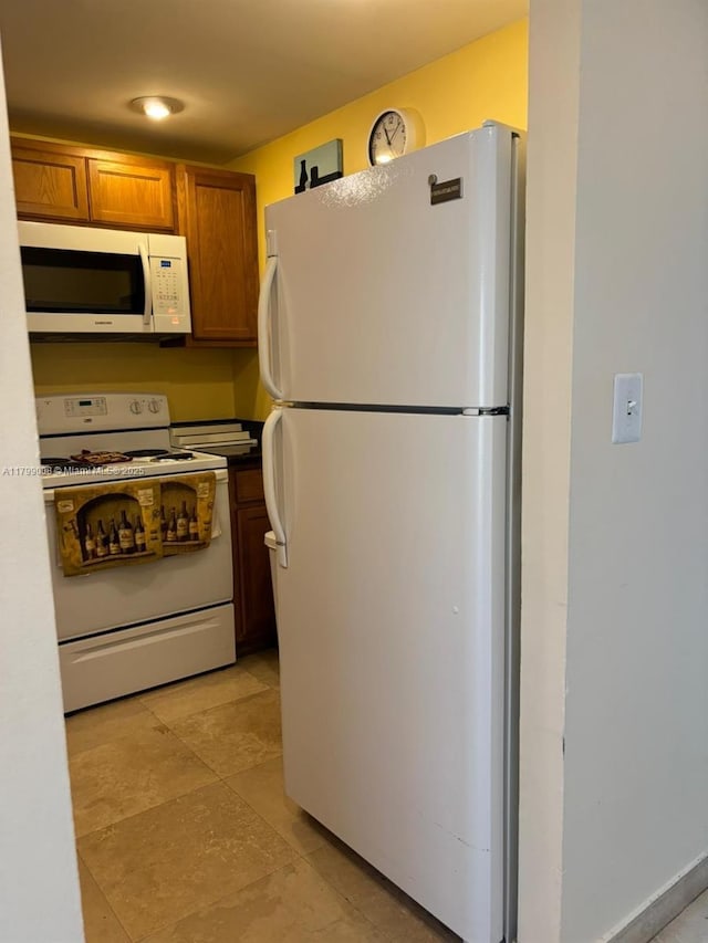 9420 Sunrise Lakes Blvd Unit 106, Sunrise, FL 33322 - kitchen featuring white appliances, brown cabinetry, and dark countertops