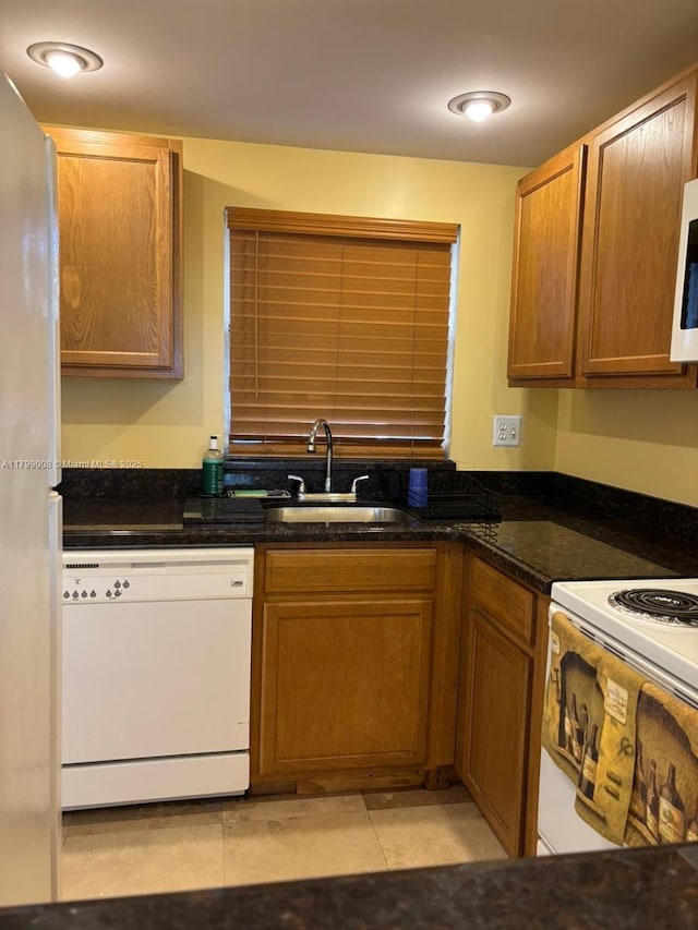 9420 Sunrise Lakes Blvd Unit 106, Sunrise, FL 33322 - kitchen with white appliances and brown cabinetry