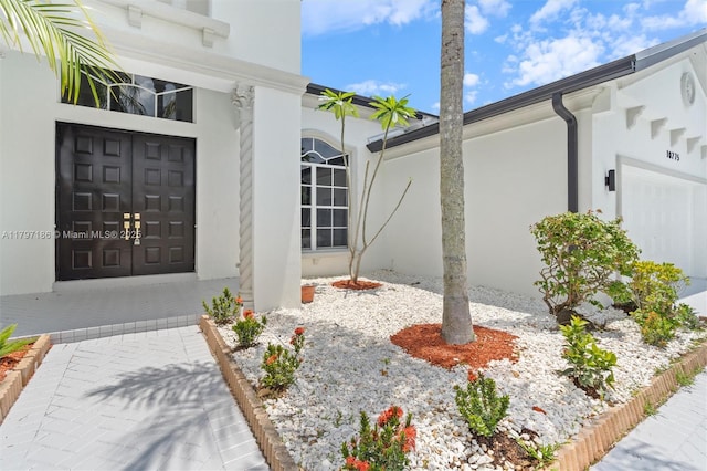 10275 Oak Meadow Ln, Lake Worth, FL 33449 - entrance to property with stucco siding and a garage