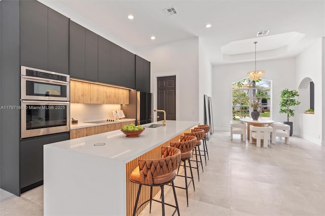 10275 Oak Meadow Ln, Lake Worth, FL 33449 - kitchen with modern cabinets, stainless steel double oven, a kitchen breakfast bar, baseboards, and a spacious island