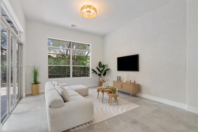 10275 Oak Meadow Ln, Lake Worth, FL 33449 - living area with healthy amount of natural light, baseboards, and concrete floors