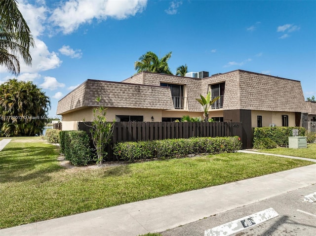4102 Waterview Cir, Palm Springs, FL 33461 - view of front of property featuring mansard roof, a shingled roof, and stucco siding