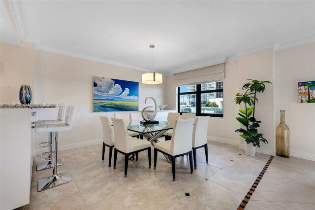 9801 Collins Ave Unit 5S, Bal Harbour, FL 33154 - dining space featuring crown molding, baseboards, and light tile patterned floors