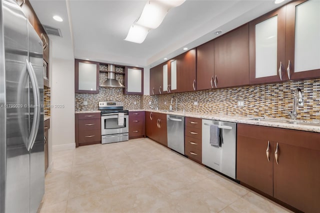 9801 Collins Ave Unit 5S, Bal Harbour, FL 33154 - kitchen with appliances with stainless steel finishes, wall chimney exhaust hood, a sink, tasteful backsplash, and glass insert cabinets