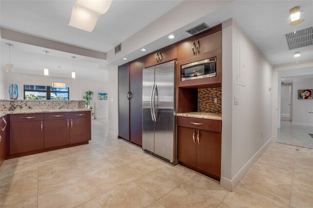 9801 Collins Ave Unit 5S, Bal Harbour, FL 33154 - kitchen featuring appliances with stainless steel finishes, tasteful backsplash, light stone countertops, pendant lighting, and recessed lighting