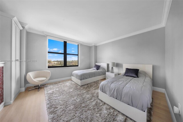 9801 Collins Ave Unit 5S, Bal Harbour, FL 33154 - bedroom featuring ornamental molding, light wood-style flooring, and baseboards