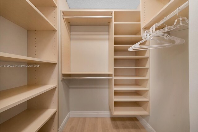 9801 Collins Ave Unit 5S, Bal Harbour, FL 33154 - walk in closet featuring wood finished floors