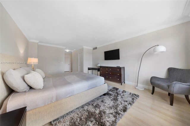 9801 Collins Ave Unit 5S, Bal Harbour, FL 33154 - bedroom with light wood-style flooring, crown molding, and baseboards