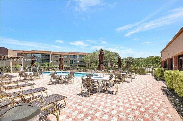 2791 N Pine Island Rd Unit 301, Sunrise, FL 33322 - view of patio / terrace with a community pool and fence