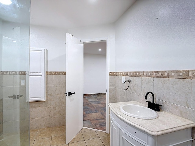 10227 SW 53rd Ct, Cooper City, FL 33328 - bathroom featuring tile walls, wainscoting, vanity, a tile shower, and tile patterned flooring