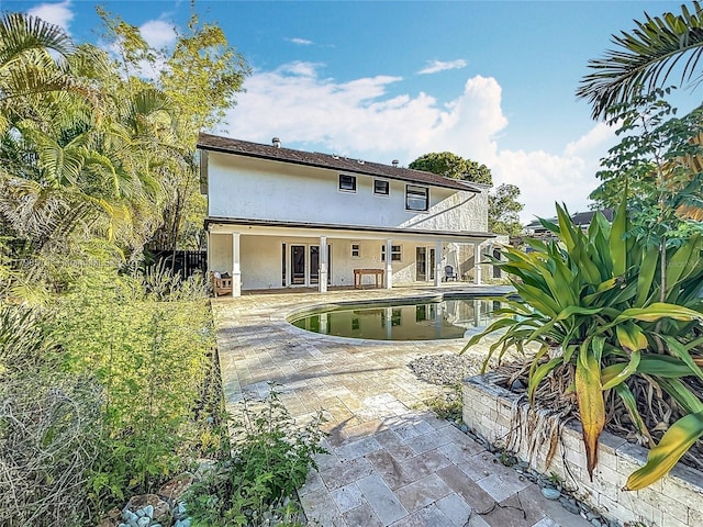 10227 SW 53rd Ct, Cooper City, FL 33328 - rear view of property featuring a patio, stucco siding, an outdoor pool, and french doors