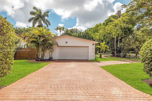615 NE 115th St, Biscayne Park, FL 33161 - view of front facade featuring decorative driveway, an attached garage, and stucco siding