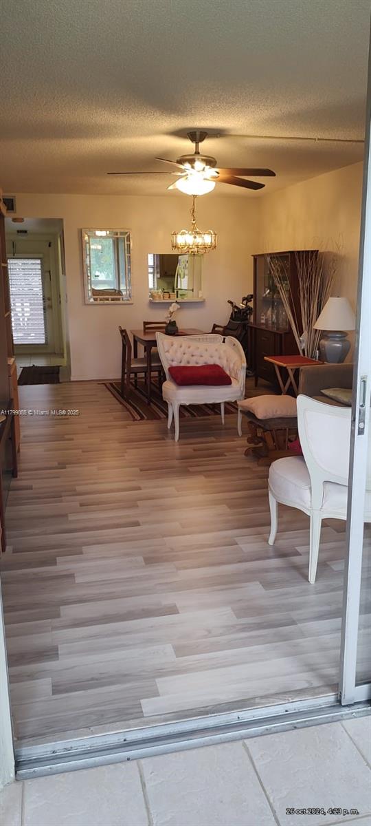 9581 Sunrise Lakes Blvd Unit 202, Sunrise, FL 33322 - dining area featuring a ceiling fan, a textured ceiling, and wood finished floors