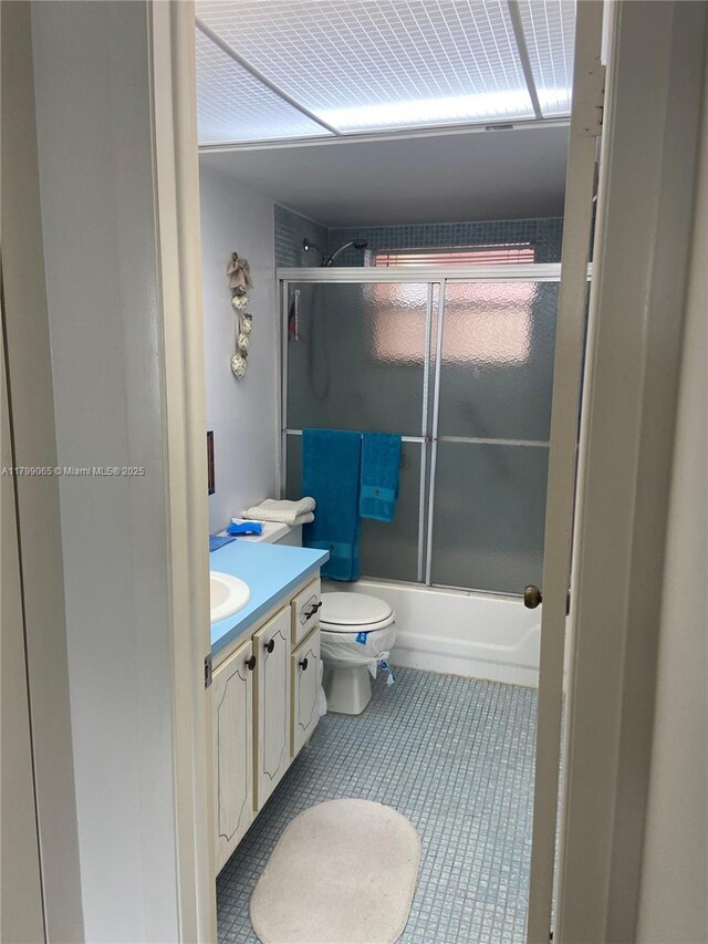 9581 Sunrise Lakes Blvd Unit 202, Sunrise, FL 33322 - bathroom with vanity, toilet, bath / shower combo with glass door, and tile patterned floors
