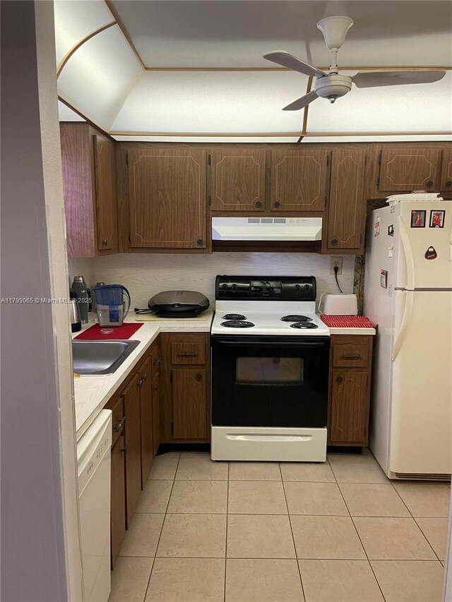 9581 Sunrise Lakes Blvd Unit 202, Sunrise, FL 33322 - kitchen with white appliances, under cabinet range hood, light countertops, light tile patterned floors, and a sink