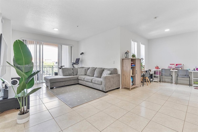 living room featuring healthy amount of natural light, light tile patterned floors, and recessed lighting