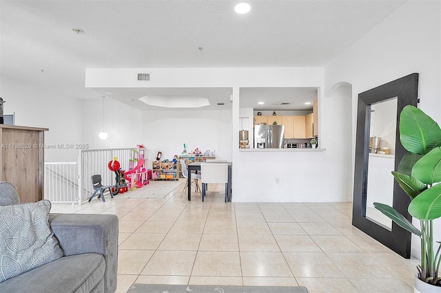 living room featuring light tile patterned floors and recessed lighting