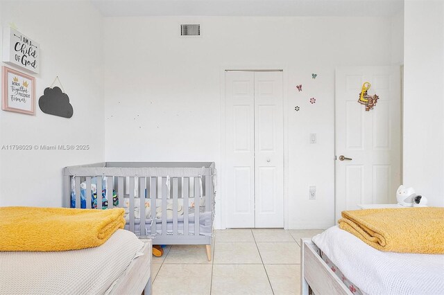 bedroom with a closet and light tile patterned floors