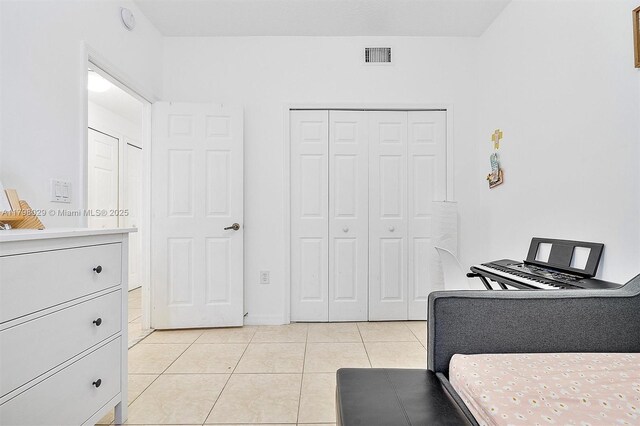 bedroom featuring light tile patterned floors and a closet