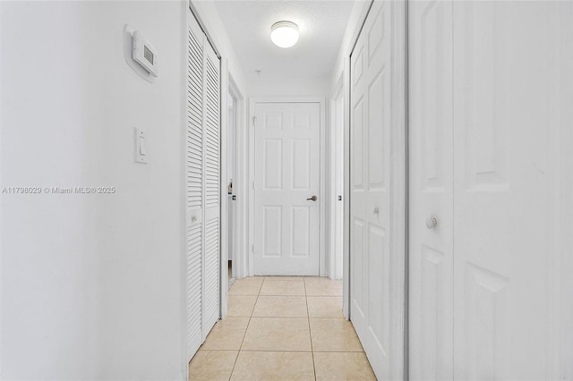 corridor featuring light tile patterned floors